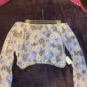 Off the shoulder floral print, purple top.